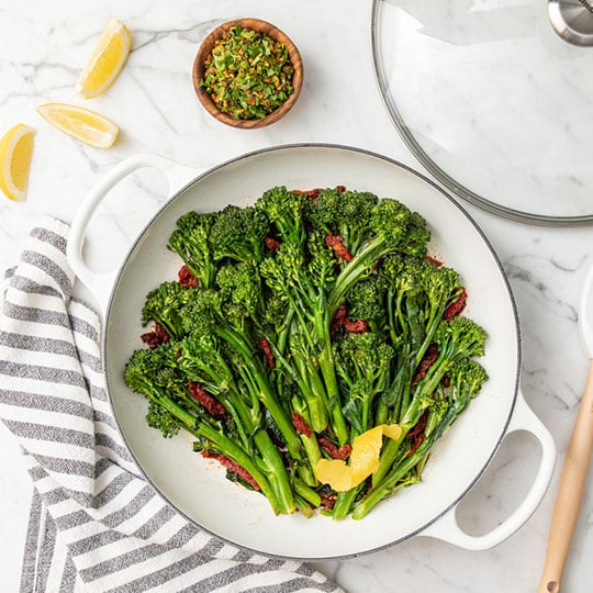 bright green broccoli in a white braiser