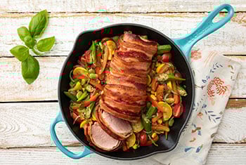 bacon wrapped pork loin in a skillet