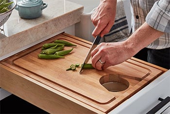 person chopping herbs on a cutting board