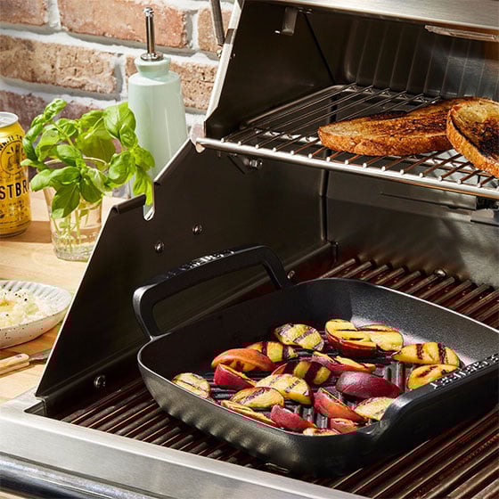 grilling peaches on an outdoor grill