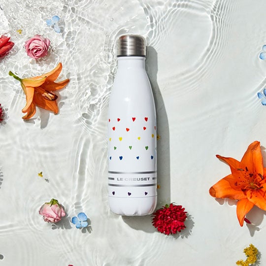 metal water bottle wth the tiny rainbow heart pattern and a Le Creuset text logo