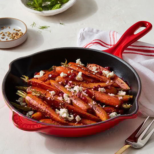 carrots in a cerise red skillet