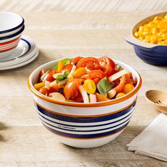 tomato salad next to a bowl of macaroni and cheese
