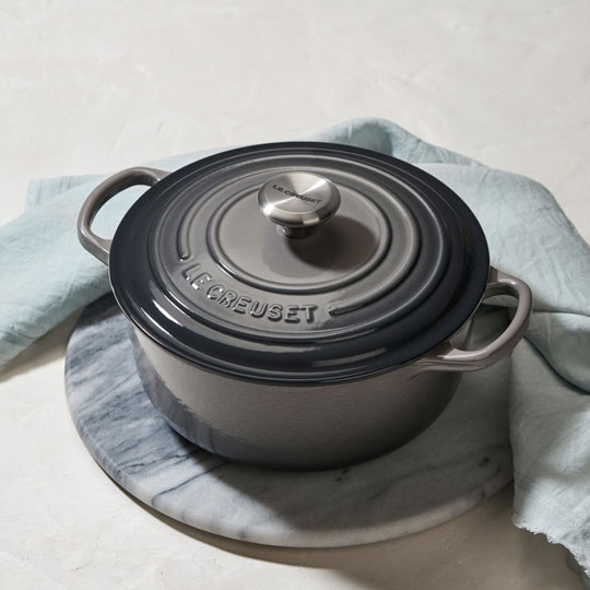 small oyster gray-brown dutch oven on a marble trivet