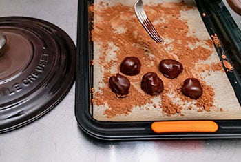 rolling truffles in cocoa powder