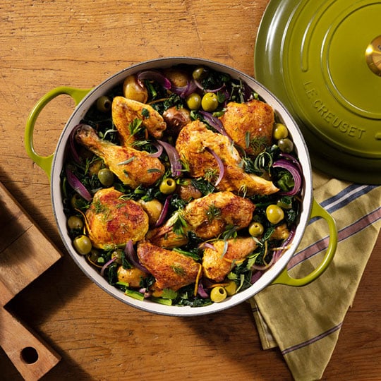 chicken, olives and veggies in an olive green chef's oven