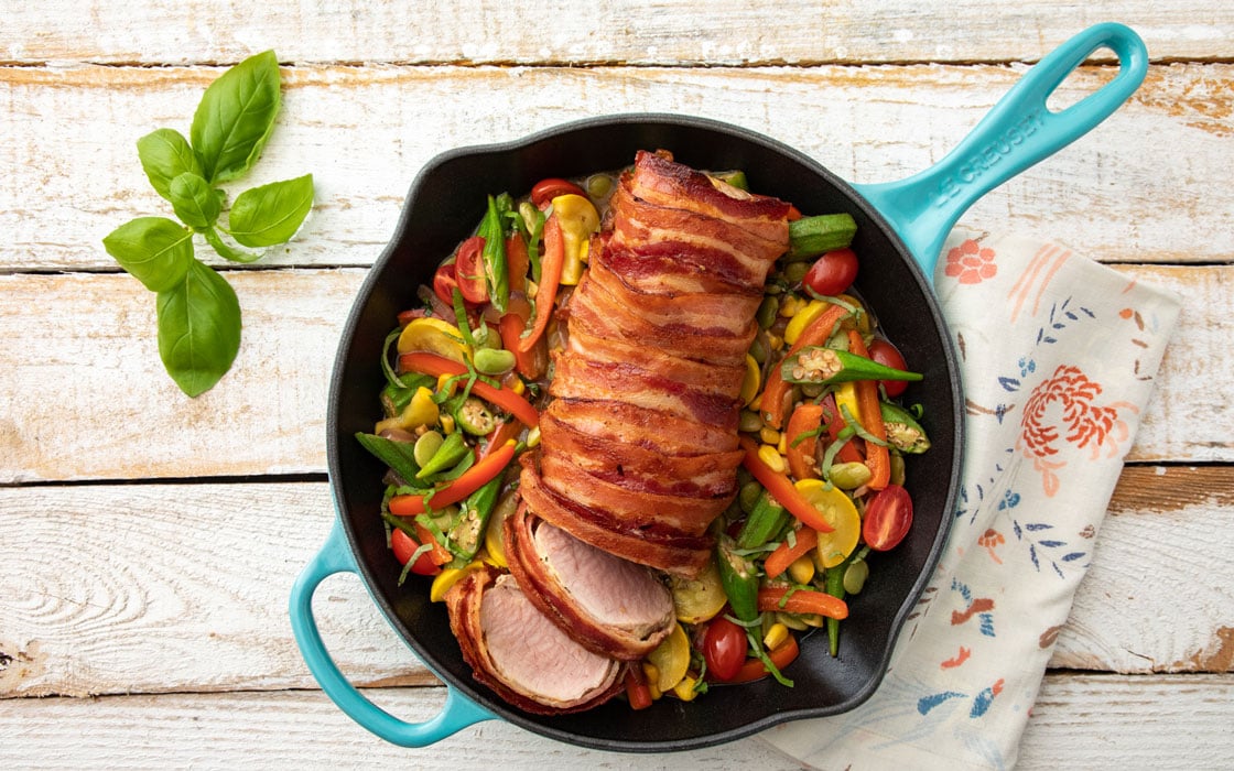 bacon wrapped pork loin in a skillet
