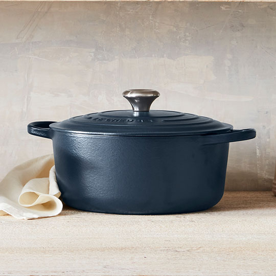 navy blue dutch oven on a tabletop