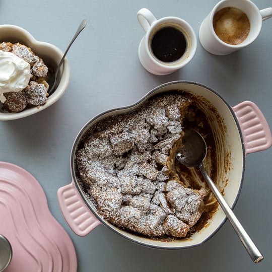 bread pudding in a heart cocotte dusted with powdered sugar