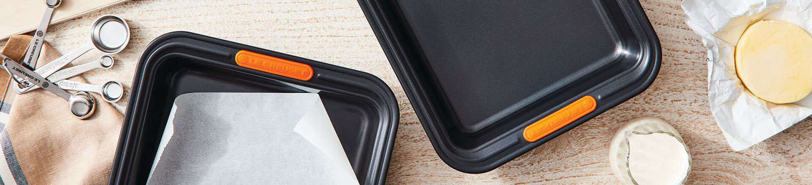 nonstick metal bakeware alongside eggs and ingredients