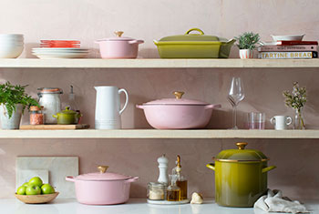 shelves of pink and green cookware