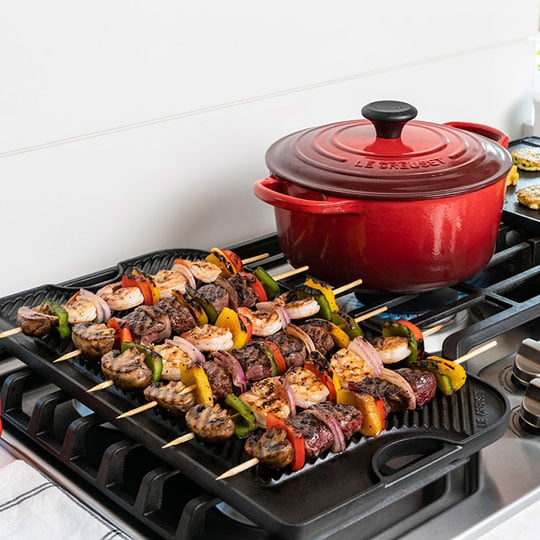 skewers of kebabs on a grill