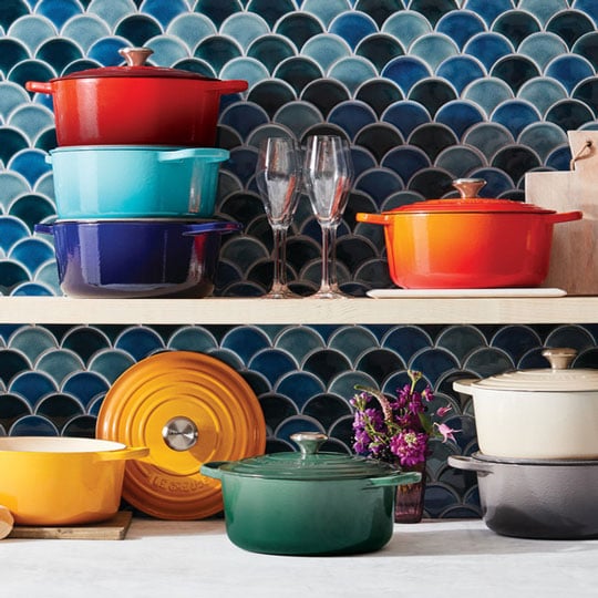 dutch ovens in different colors on a countertop
