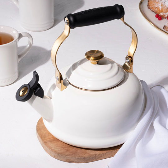 white tea kettle with gold accents