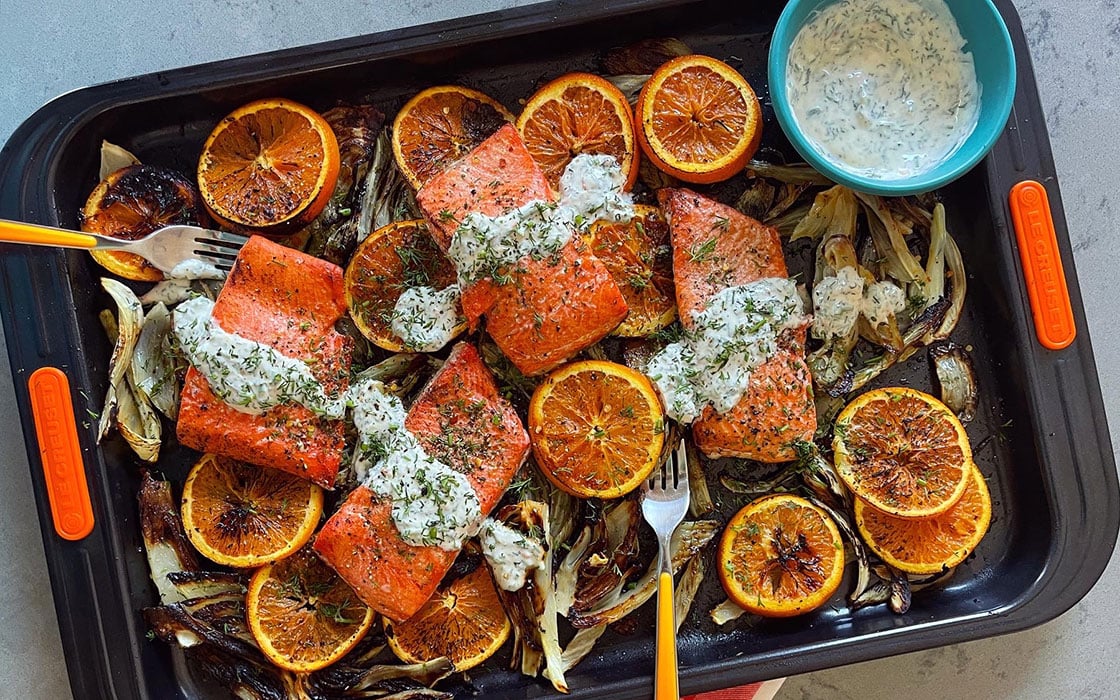salmon and oranges on a sheet pan