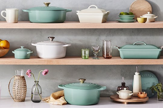 light green and white cookware on shelves