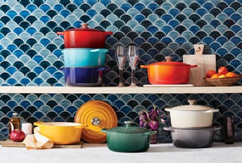 assorted colorful cookware fills shelves