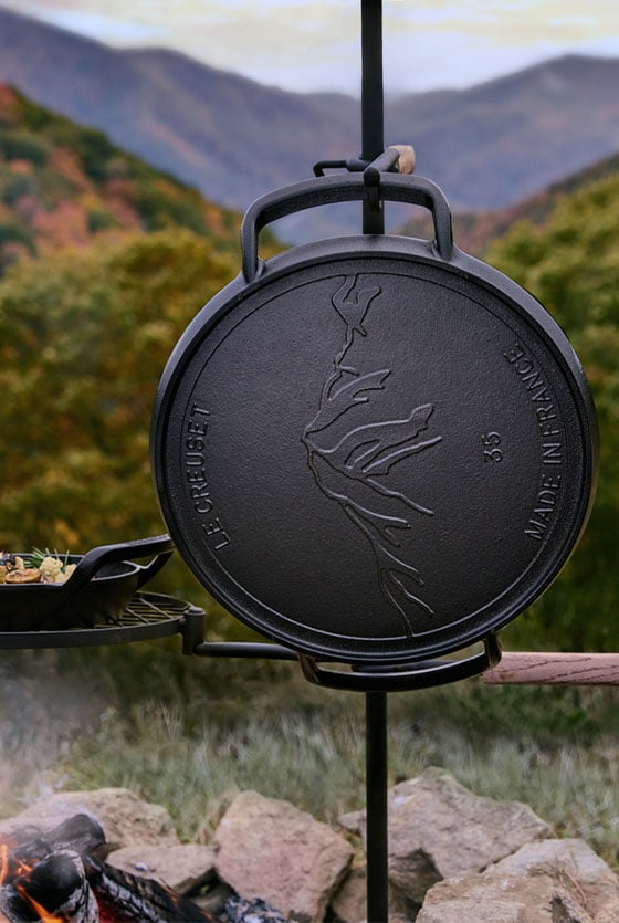 alpine skillet hangs by a campfire