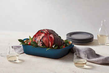 roasted ham in a cast iron roaster