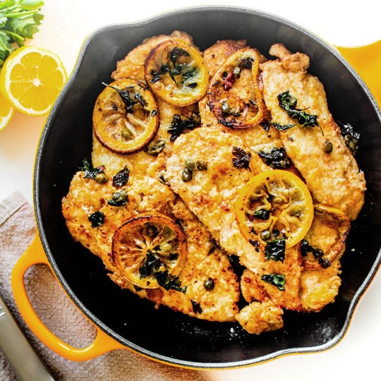 lemon pork schnitzel in a nectar yellow skillet
