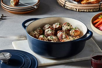 shallow dutch oven filled with meatballs