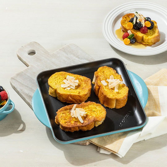 thick slices of french toast on a griddle