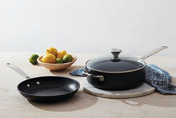 non-stick pansd on a counter with lemons