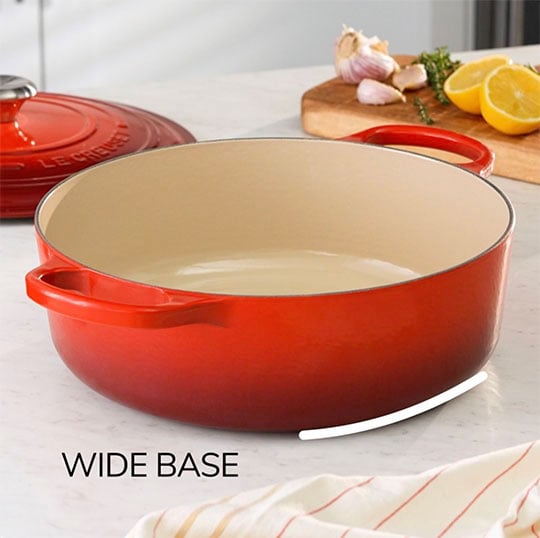 shot of the wide dutch oven showing its somewhat shallow depth and large surface area for cooking with text that reads: wide base
