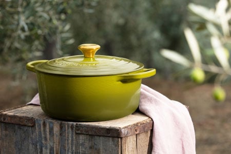 olive dutch oven on a wooden crate