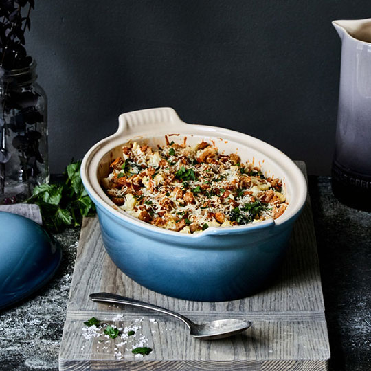 hearty casserole in a blue stoneware covered dish