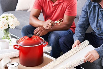 wrapping a stockpot with festive paper