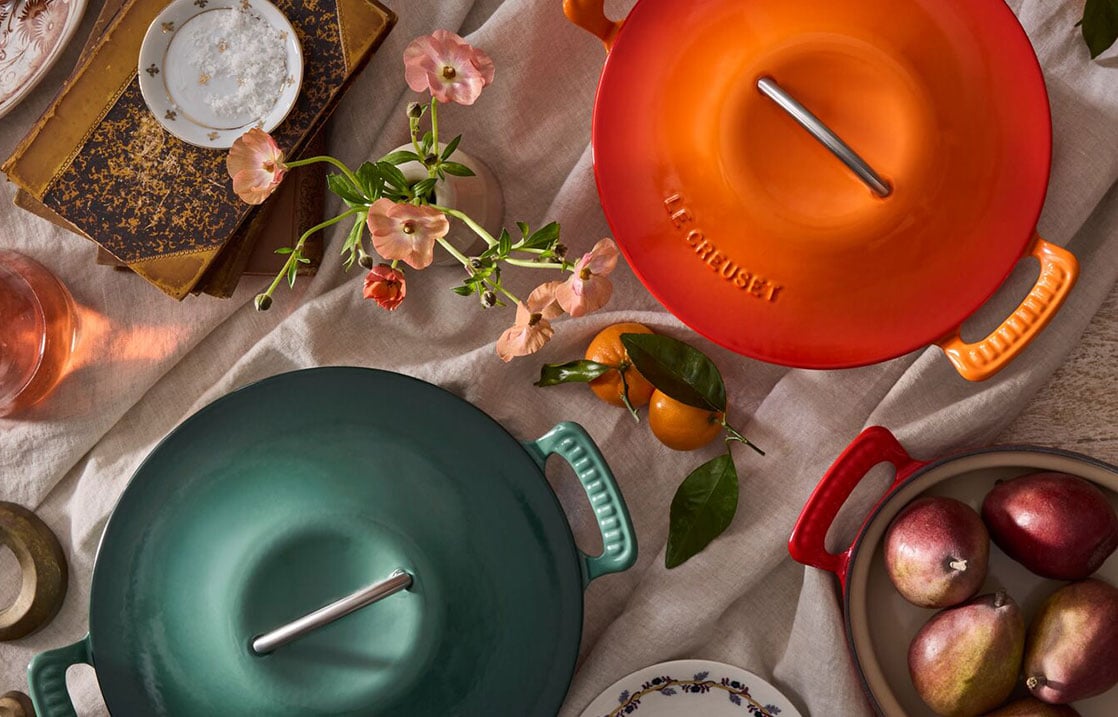 cast iron casseroles on a tabletop with fall fruits