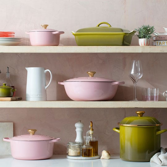 pink, green and white cookware on a shelf