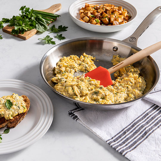 scrambled eggs in a stainless fry pan