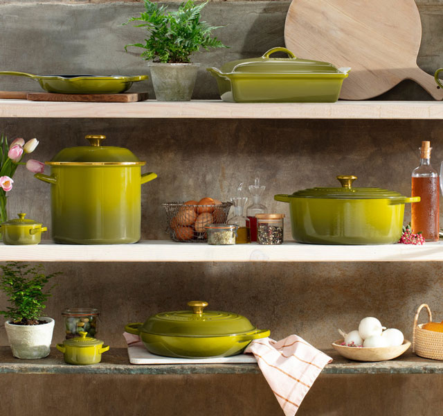 olive cookware on shelves with home decor