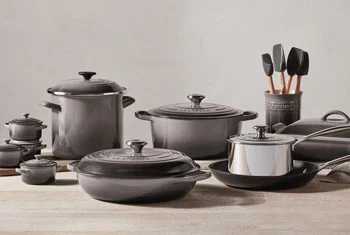 a large collection of oyster gray cookware