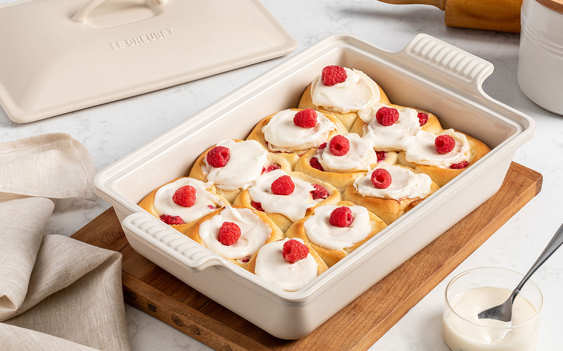 rolls topped with whipped cream and raspberries