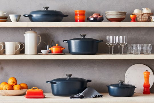 assorted cookware including mate navy and flame orange